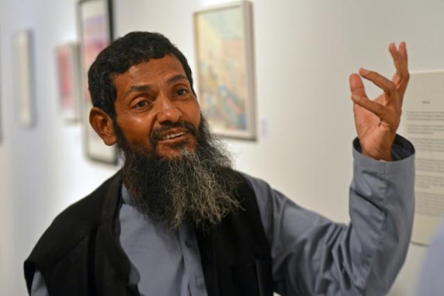 Ahmed Rabbani, a Pakistani recently freed from Guantanamo Bay prison, speaks to AFP during an exhibition of his work in Karachi