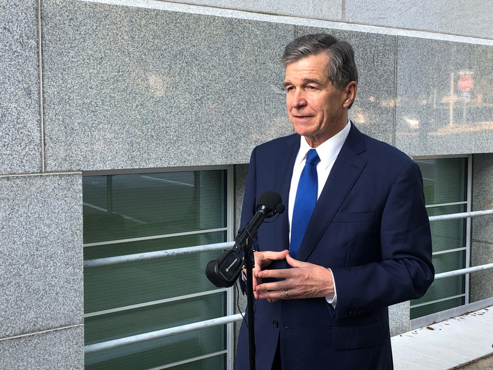 North Carolina Gov. Roy Cooper speaks to reporters, Tuesday, Oct. 5, 2021, outside of the Department of Transportation building in Raleigh, N.C., following a meeting of the Council of State (AP Photo/Gary D. Robertson)