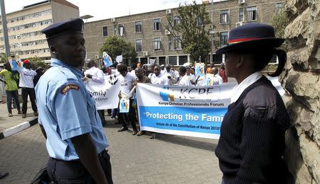 Police stand guard as members of the anti-gay caucus gather outside the Parliament while chanting slogans against the lesbian, gay, bisexual, and transgender (LGBT) community in Kenya's capital Nairobi July 6, 2015. REUTERS/Thomas Mukoya