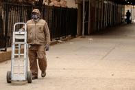 A UPS delivery driver wears a mask as he walks down the street during an ongoing outbreak of the coronavirus disease (COVID-19) in the Brooklyn borough of New York