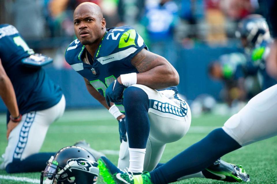 Seattle Seahawks running back Adrian Peterson (21) stretches prior to the start of an NFL game against the San Francisco 49ers on Sunday at Lumen Field in Seattle.