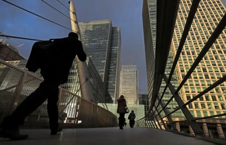 FILE PHOTO: People walk through the Canary Wharf financial district of London