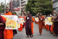 Sri Lankan student Buddhist monks shout slogans as they march demanding President Gotabaya Rajapaksa resign over the economic crisis in Colombo, Sri Lanka, Monday, June 20, 2022. (AP Photo/Eranga Jayawardena)