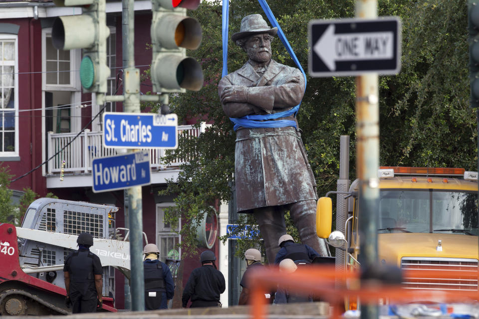 FILE - A statue of Confederate General Robert E. Lee is lowered to a truck for removal Friday, May 19, 2017, from Lee Circle in New Orleans.A New Orleans city council member is pushing to change a street currently named after Confederate Gen. Robert E. Lee and replace it with one the city’s most famous musicians, Allen Toussaint. (AP Photo/Scott Threlkeld, File)