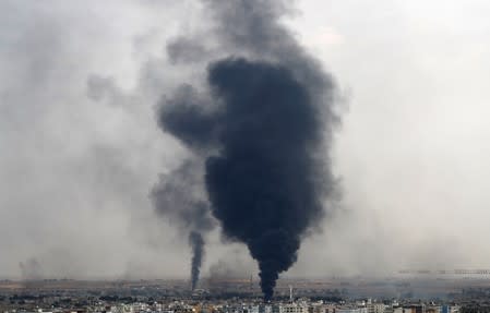 Smoke rises over the Syrian town of Ras al Ain, as seen from the Turkish border town of Ceylanpinar