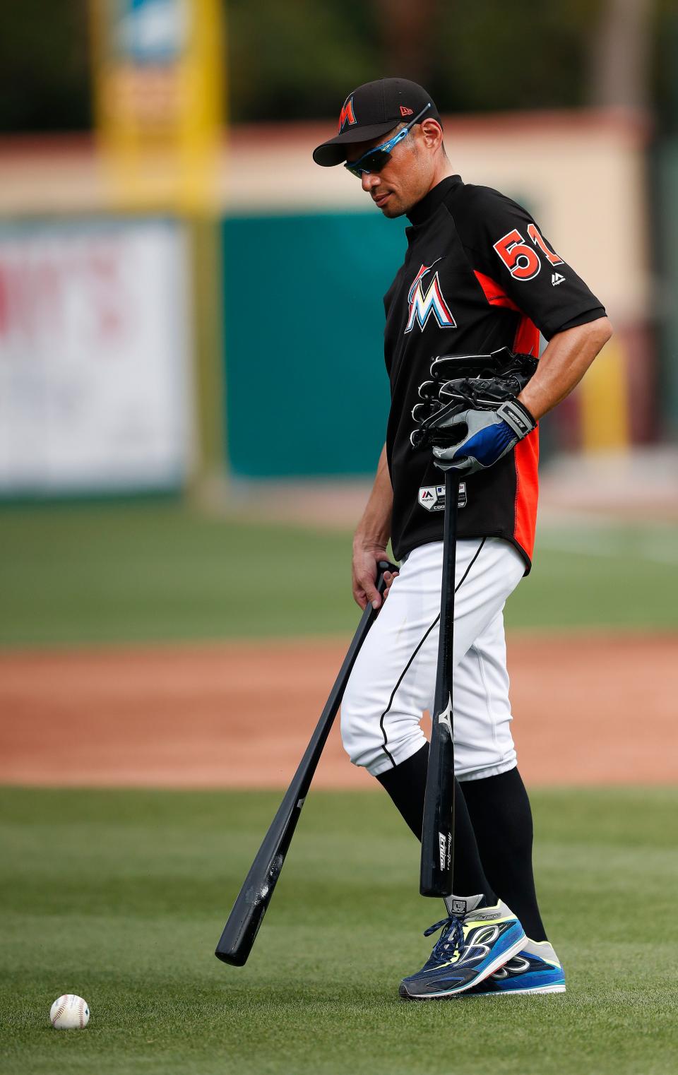 Marlins rightfielder Ichiro Suzuki picks up batting practice balls before a spring training game against the Tigers on Friday, March 31, 2017 in Jupiter, Fla.