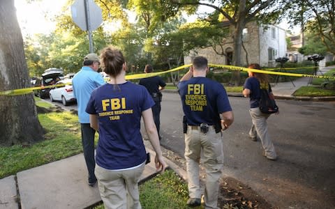 FBI, Bureau of Alcohol, Tobacco, Firearms and Explosives (ATF), and Houston Police work at the scene of a "law enforcement operation" led by the FBI on the 2000 block of Albans Road Monday - Credit: Godofredo A. Vasquez/Houston Chronicle via AP