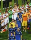 Germany's players applaud the Argentina team as they walk past to collect their medals after Germany won their 2014 World Cup final at the Maracana stadium in Rio de Janeiro July 13, 2014. REUTERS/Ricardo Moraes (BRAZIL - Tags: SOCCER SPORT WORLD CUP)