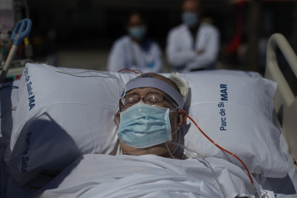 Francisco España, 60, spends time in front of the beach near the "Hospital del Mar" in Barcelona, Spain, Friday, Sept. 4, 2020. A hospital in Barcelona is studying how short trips to the beach may help COVID-19 patients recover from long and traumatic intensive hospital care. The study is part of a program to “humanize” ICUs. Since re-starting it in early June, the researchers have anecdotally noticed that even ten minutes in front of the blue sea waters can improve a patient’s emotional attitude. (AP Photo/Emilio Morenatti)