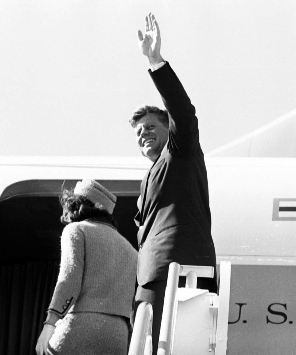 President John F. Kennedy and Jackie Kennedy enter Air Force One to fly from Fort Worth to Dallas. JFK waves to crowd at Carswell Air Force Base.