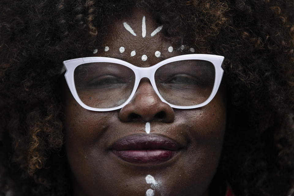 A woman participates in the Black Women's March against racism, violence and social inequality, at Copacabana beach in Rio de Janeiro, Brazil, Sunday, July 31, 2022. (AP Photo/Bruna Prado)