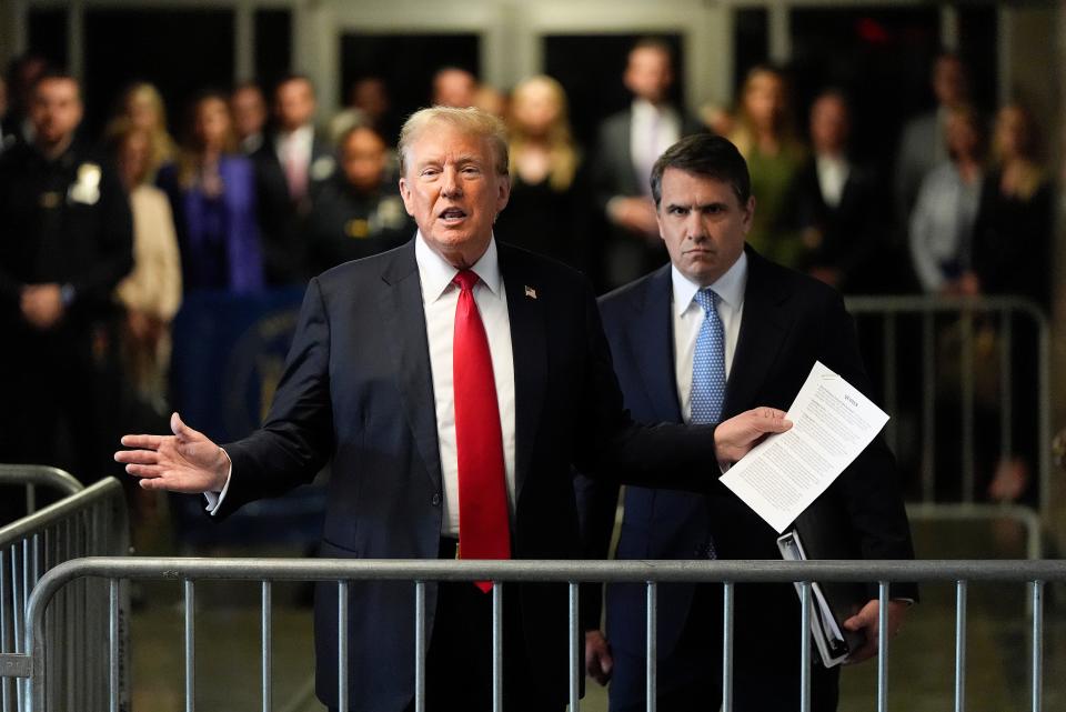 Former President Donald Trump speaks to members of the media upon arriving at Manhattan Criminal Court (AP)