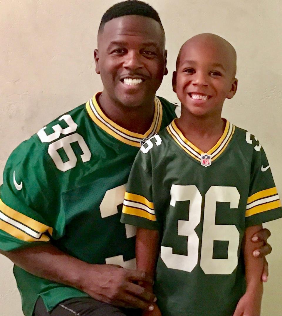 Former Green Bay Packer LeRoy Butler, shown with his son LeRoy, makes 32 side dishes, his favorite part of the Thanksgiving meal.