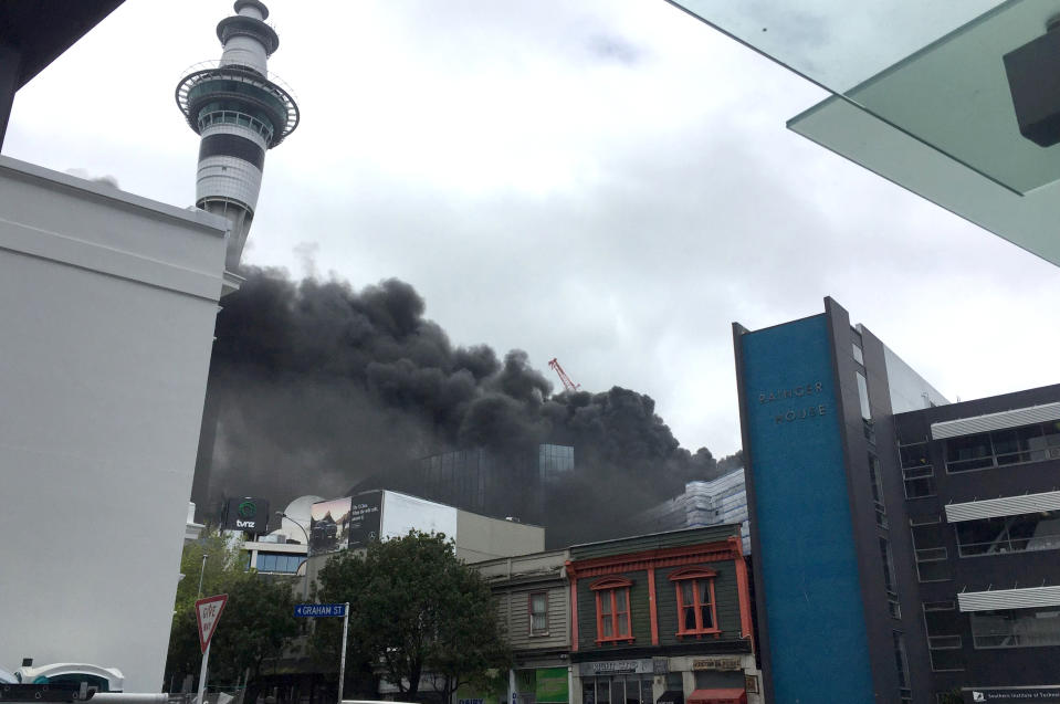 Smoke billows across the central business district skyline Tuesday, Oct. 22, 2019, in Aukland, New Zealand. A large fire that broke out on the roof of a convention center that's under construction in downtown Auckland sent plumes of thick black smoke over New Zealand's largest city. (Duncan Bridgeman/New Zealand Herald via AP)