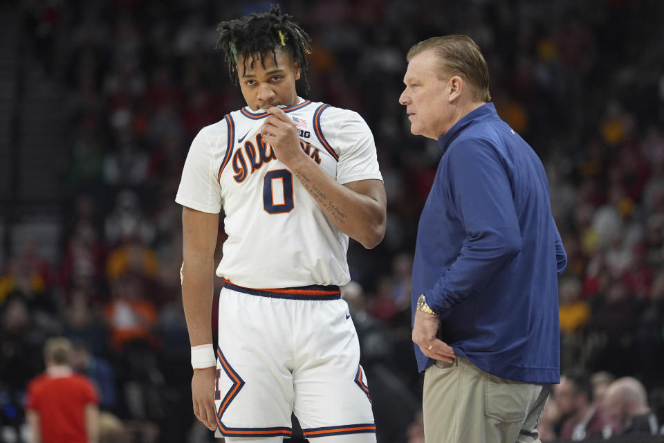 Illinois guard Terrence Shannon Jr. (0) and head coach Brad Underwood talk during the first half of an NCAA college basketball game against Wisconsin in the championship of the Big Ten Conference tournament, Sunday, March 17, 2024, in Minneapolis. (AP Photo/Abbie Parr)