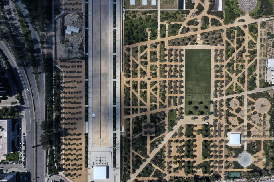 In this Thursday, April 2, 2020 aerial photo, a view of the empty Stavros Niarchos Foundation Cultural Center and Syngrou avenue during the lockdown. Deserted squares, padlocked parks, empty avenues where cars were once jammed bumper-to-bumper in heavy traffic. The Greek capital, like so many cities across the world, has seen its streets empty as part of a lockdown designed to stem the spread of the new coronavirus. (AP Photo/Thanassis Stavrakis)