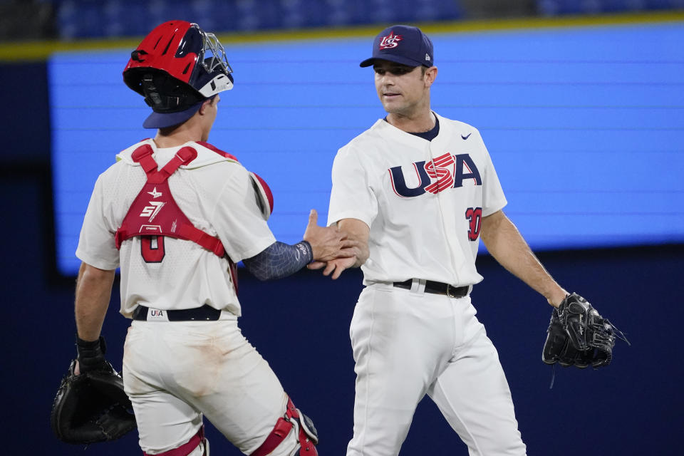 United States' Mark Kolozsvary, left, and David Robertson celebrate their win after a baseball game against South Korea at the 2020 Summer Olympics, Saturday, July 31, 2021, in Yokohama, Japan. United States won 4-2. (AP Photo/Sue Ogrocki)