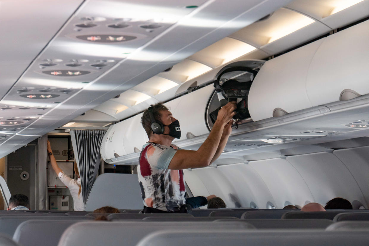 A male passenger during the flight as seen with the mandatory facemask. Flying with Lauda Airbus A320 airplane with registration 9H-LMJ during the Covid-19 Coronavirus pandemic with passenger and crew wearing facemask. Laudamotion or Lauda is an Austrian low-cost carrier owned by Ryanair and operating by Ryanair codes FR for IATA, RYR for ICAO and RYANAIR callsign. The budget airline carrier is based in Vienna International Airport  VIE LOWW or Flughafen Wien-Schwechat in Austria with a fleet of 28 Airbus Aircraft. Vienna, Austria on October 12, 2020 (Photo by Nicolas Economou/NurPhoto via Getty Images)