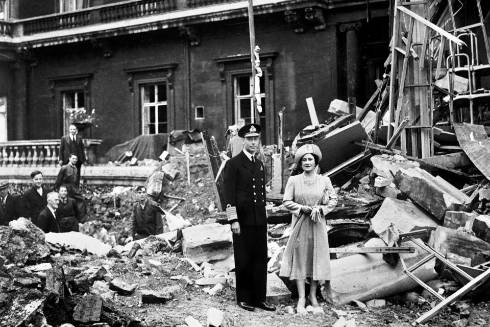 King George VI and the Queen Mother standing amid the bomb damage at Buckingham Palace (PA)