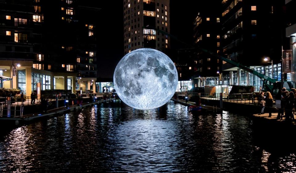 Jerram’s replica of a moon dangles over a river in Leeds, England.