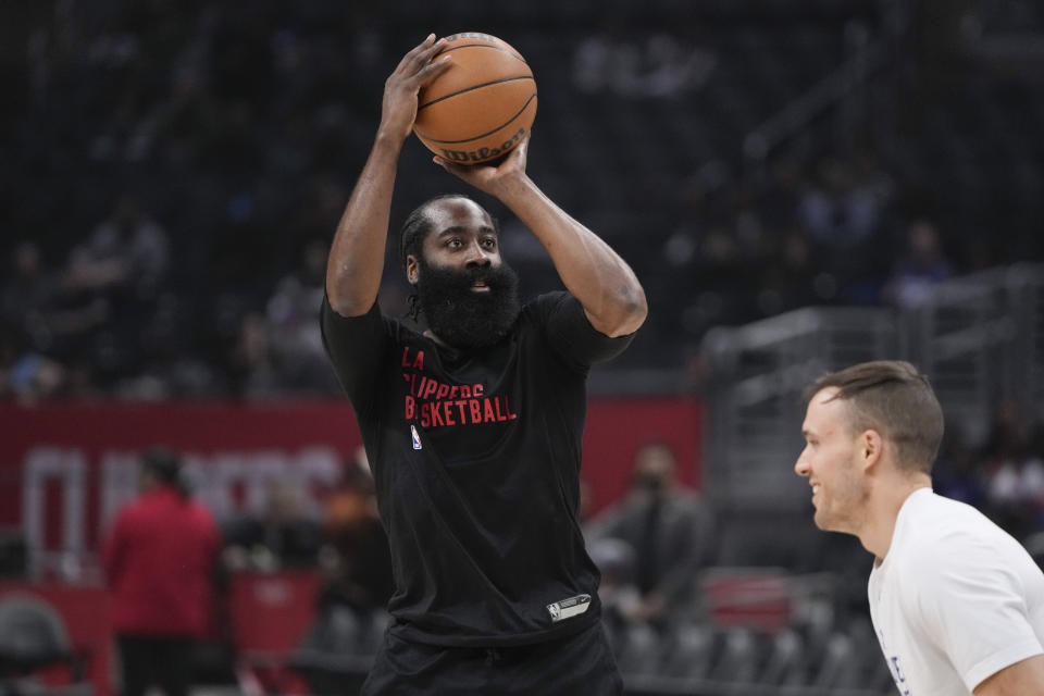 Los Angeles Clippers guard James Harden, left, warms up before an NBA basketball game against the Washington Wizards, Friday, March 1, 2024, in Los Angeles. (AP Photo/Ryan Sun)