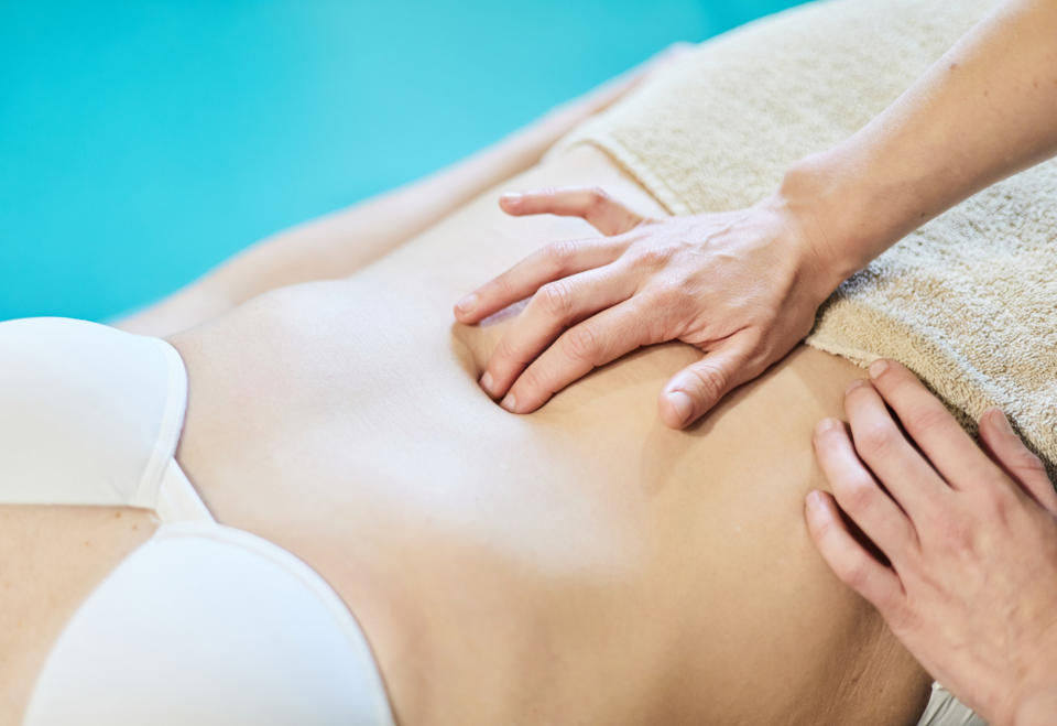 Stock photo of an abdominal massage during physical therapy