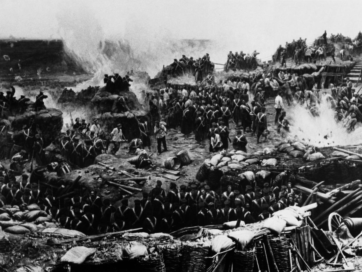 Black and White photo of hundreds of soldiers shooting each other with rifles on a battlefield