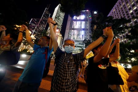 Protesters hold hands to form a human chain during a rally to call for political reforms in Hong Kong's Central district