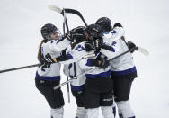Minnesota's Taylor Heise (27) celebrates after her goal with Lee Stecklein (2), Liz Schepers (21) and Abby Boreen (24) during third-period action in Game 5 of a PWHL hockey playoff series against Toronto in Toronto, Friday, May 17, 2024. (Mark Blinch/The Canadian Press via AP)