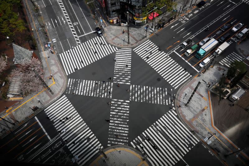 Less than usual passersby are seen at a pedestrian crossing at Ginza shopping and amusement district during the outbreak of coronavirus disease in Tokyo