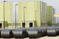 Workers stand in the steel coil yard at the ThyssenKrupp Steel USA factory in Calvert, Alabama November 22, 2013. REUTERS/Lyle Ratliff