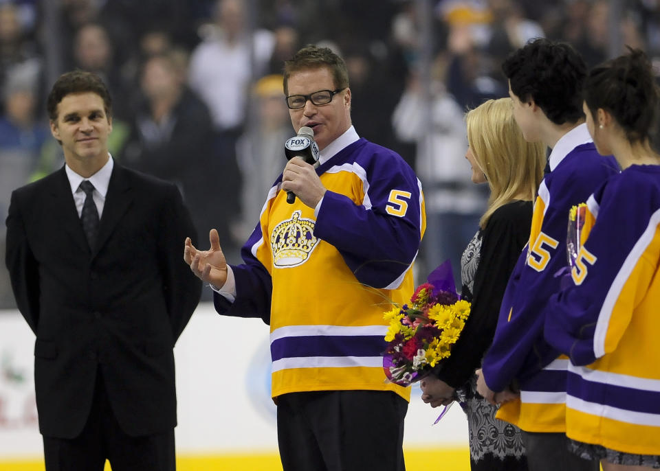 FILE - Hockey Hall of Fame and a four-time Stanley Cup winner Larry Murphy is honored before the start of an NHL hockey game between the Los Angeles Kings and the New York Islanders, Saturday, Dec. 7, 2013, in Los Angeles. When the NHL implemented 3-on-3 play in overtime nearly a decade ago, the idea was to see the most speed and skill hockey had to offer. In recent years, 3 on 3 has slowed down. Larry Murphy coaches a 3ICE team and believes the NHL should adopt the over-and-back rule.(AP Photo/Gus Ruelas, File)