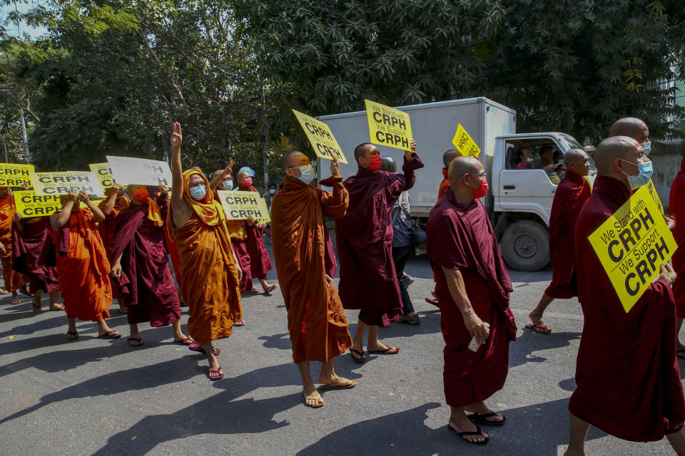 Buddhist monks lead an anti-coup protest march in Mandalay, Myanmar, Saturday, Feb. 27, 2021. Myanmar security forces cracked down on anti-coup protesters in the country's second-largest city Mandalay on Friday, injuring at least three people, two of whom were shot in the chest by rubber bullets and another who suffered a wound on his leg. "CRPH" in the placards stand for "Committee Representing Pyidaungsu Hluttaw." (AP Photo)