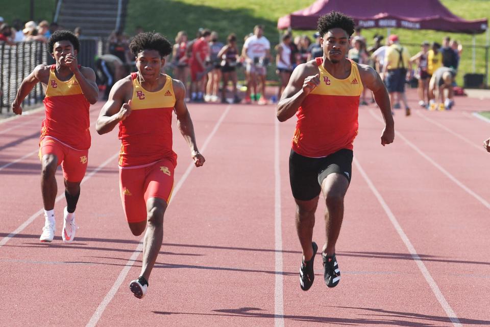 Bergen Track Championship at Old Tappan on Friday, May 21, 2021. (Left) Fabian France, of Bergen Catholic, finishes first in the 100-meter final. (Right) Adrian Taffee, of Bergen Catholic, finishes second. 