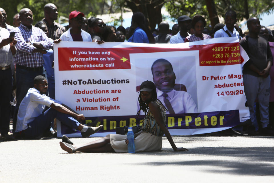 Zimbabwean doctors protest in Harare, Wednesday, Sept, 18, 2019. Zimbabwean doctors protesting the alleged abduction of a union leader were met by a line of baton- wielding police in the capital as fears grow about government repression. (AP Photo/Tsvangirayi Mukwazhi)