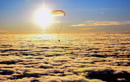 The Soyuz MS-06 capsule carrying the crew of Joe Acaba and Mark Vande Hei of the U.S., and Alexander Misurkin of Russia descends beneath a parachute just before landing in a remote area outside the town of Dzhezkazgan (Zhezkazgan), Kazakhstan, February 28, 2018. REUTERS/Alexander Nemenov/Pool