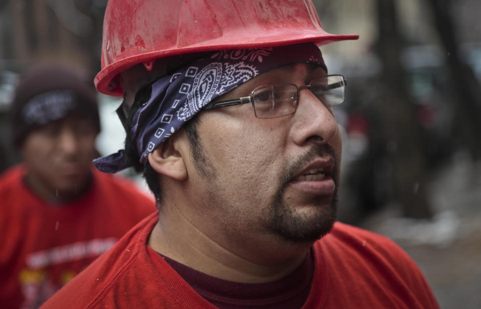 Martin Garcia, 34, a skilled day laborer from Mexico, take a break from his carpentry work at a Brooklyn brownstone for an interview on Tuesday, Dec. 10, 2013 in New York. He has improved his earnings and working condition as a day laborer by registering with a non profit labor organization. (AP Photo/Bebeto Matthews)