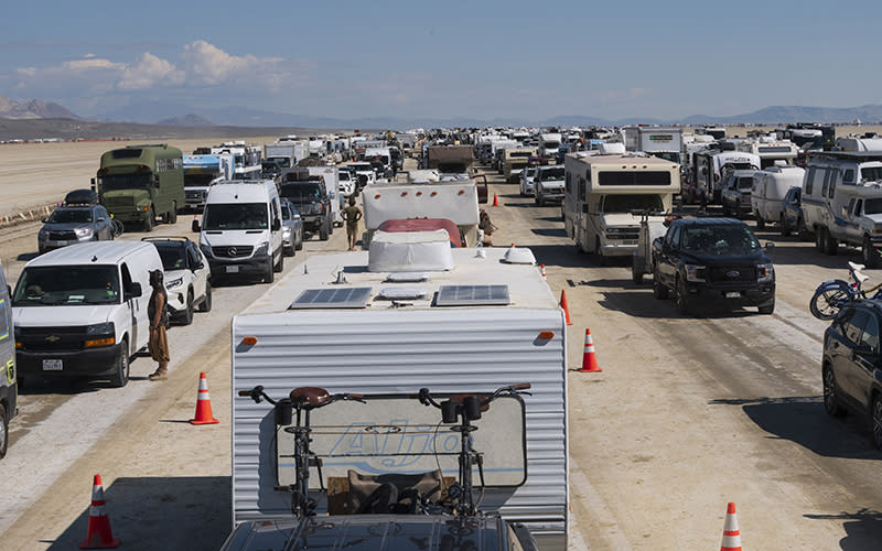 Vehicles line up to leave the Burning Man festival in Black Rock Desert