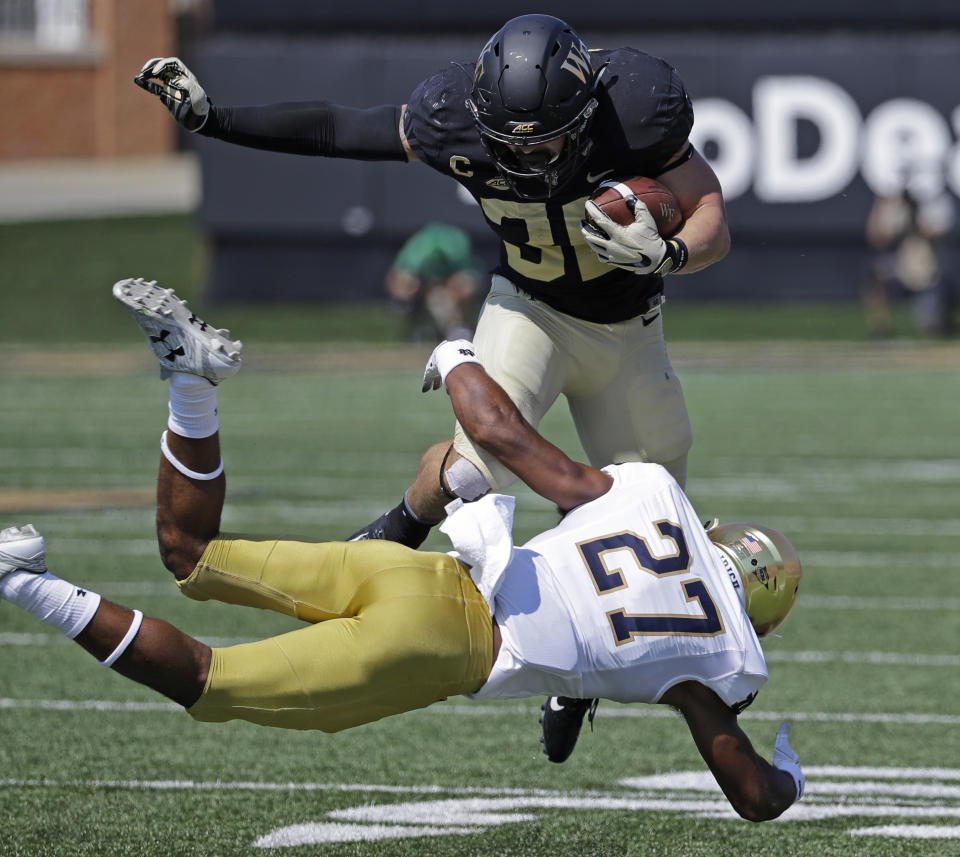 FILE - In this Sept. 22, 2018, file photo, Notre Dame's Julian Love (27) tackles Wake Forest's Cade Carney (36) in the first half of a game in Winston-Salem, N.C. Love was named to the 2018 AP All-America NCAA college football team, Monday, Dec. 10, 2018. (AP Photo/Chuck Burton, File)