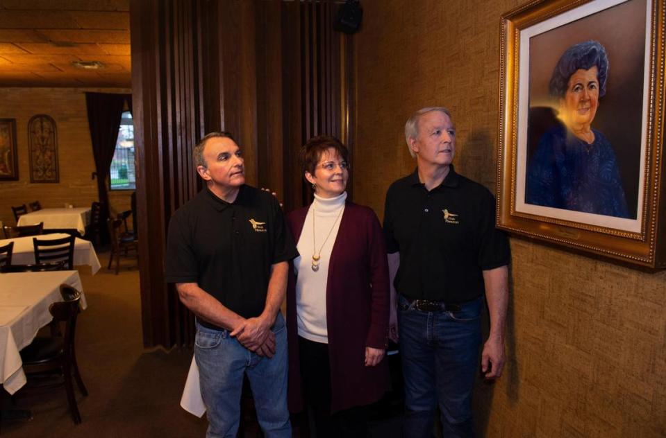 Paul, Patti and Pete Palamidessi look at a painting of their grandmother, Luisa Palamidessi hanging in the Luisa Room in at Club Pheasant in 2019. Luisa and her husband George opened the restaurant in 1935.