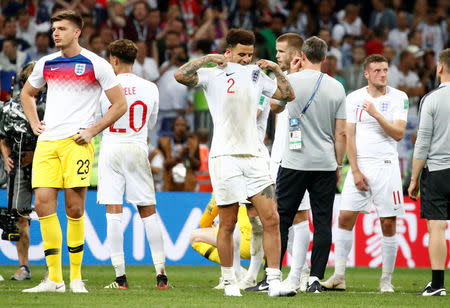 Soccer Football - World Cup - Semi Final - Croatia v England - Luzhniki Stadium, Moscow, Russia - July 11, 2018 England's Kyle Walker and teammates look dejected after the match REUTERS/Maxim Shemetov