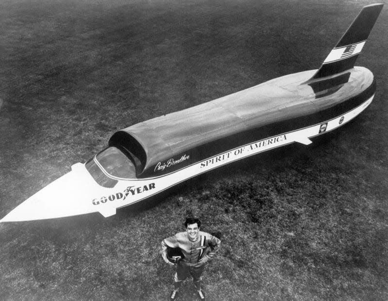 Land speed racer Craig Breedlove stands in front of his car, Spirit of America.