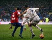 Football Socer - Real Madrid v Sporting Gijon - Spanish La Liga Santander - Santiago Bernabeu Stadium, Madrid, Spain - 26/11/16. Real Madrid's Cristiano Ronaldo and Sporting Gijon's Jorge Mere in action. REUTERS/Susana Vera