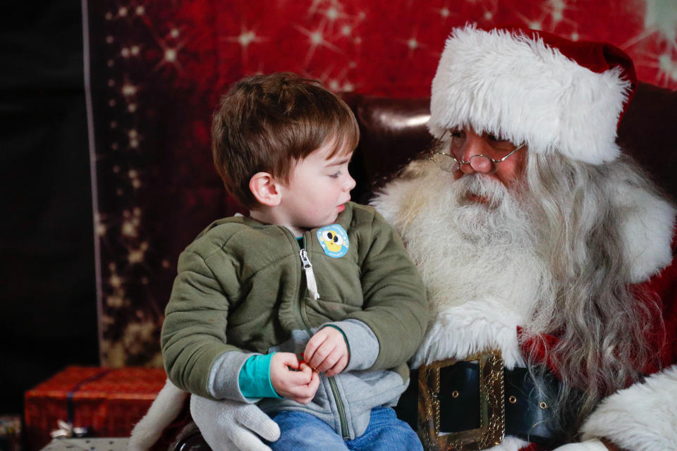 Louie Bebeau, age 3, lets Santa know what he wants for Christmas on Saturday December 10, 2022 during Savannah Santa Train at the Georgia State Railroad Museum.