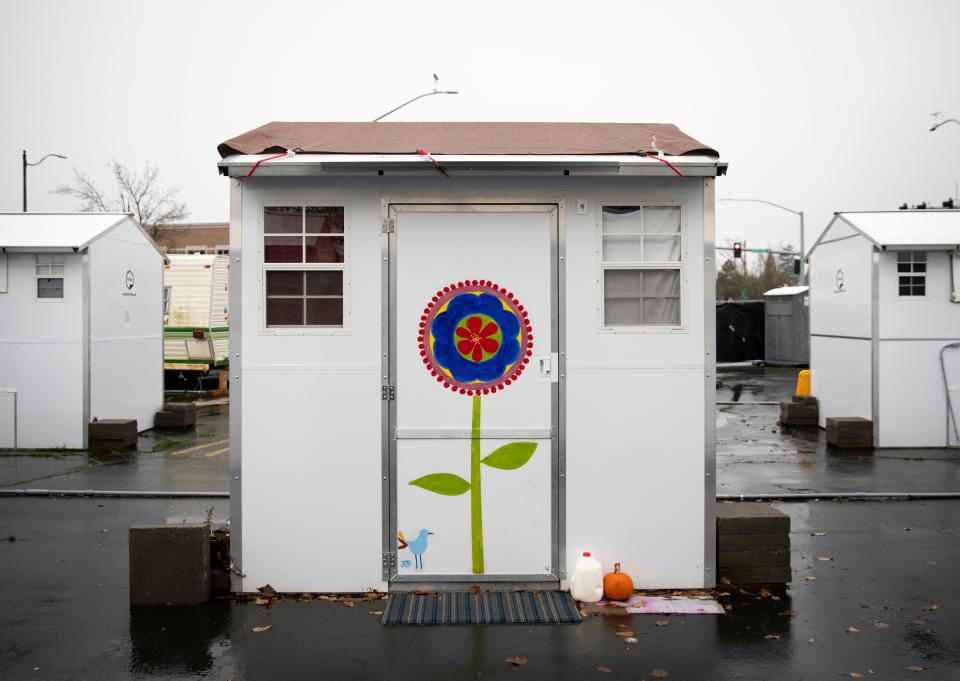 Flowers are painted on the doors of microshelters at Church at the Park.