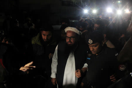 Hafiz Muhammad Saeed, chief of the banned Islamic charity Jamat-ud-Dawa, is escorted to his home where he will be under house arrest in Lahore, Pakistan January 30, 2017. REUTERS/Stringer