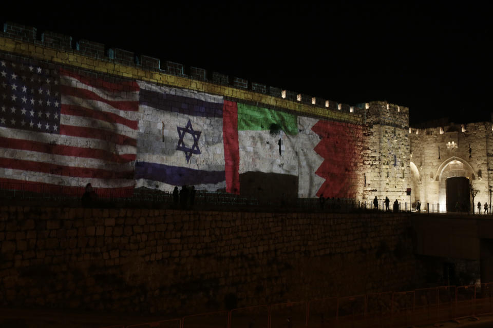 Representations of the U.S., Israeli, Emirati and Bahraini flags are projected onto a wall of Jerusalem's Old City, marking the day of a signing ceremony in Washington signifying the two Gulf nations' normalization of relations with Israel, Tuesday, Sept. 15, 2020. (AP Photo/Maya Alleruzzo)