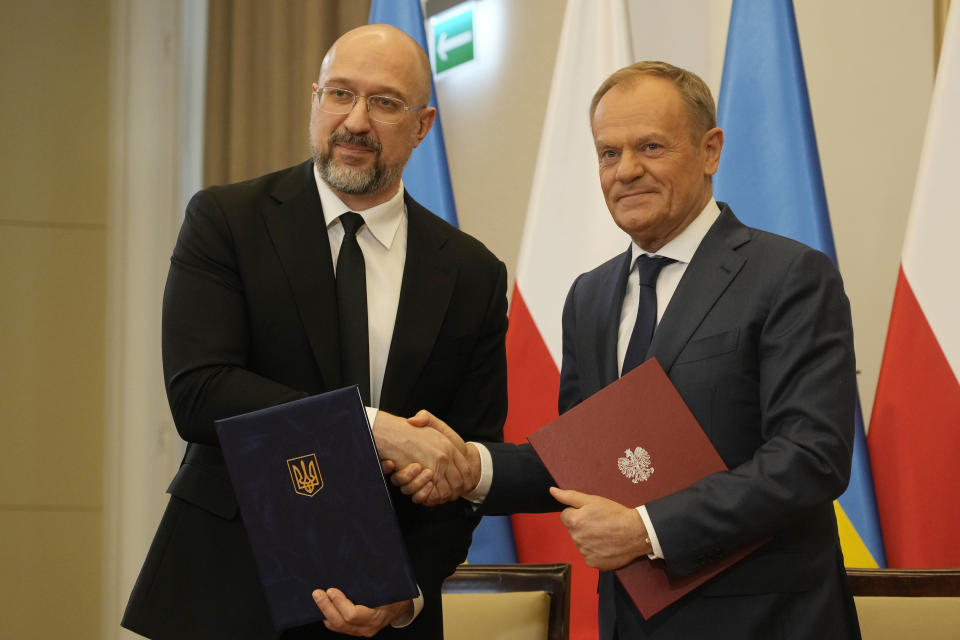 Poland's Prime Minister Donald Tusk, right, and Ukraine's Prime Minister Denys Shmyhal shake hands after bilateral meetings at the Chancellery of Prime Minister in Warsaw, Poland, Thursday, March 28, 2024. (AP Photo/Czarek Sokolowski)