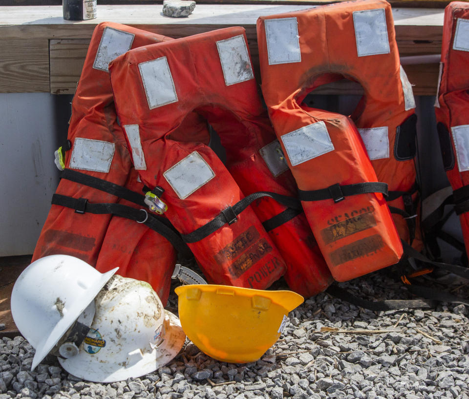 Seacor Power life jackets are lined up at Harbor Light Marina in Cocodrie, La., Monday, April 26, 2021. The United Cajun Navy and volunteers joined forces to locate 7 missing Seacor Power crew members almost 2 weeks after the lift boat capsized about 8 miles from Port Fourchon during bad weather. (Sophia Germer/The Advocate via AP)