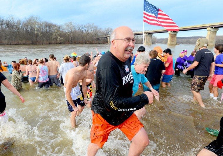 Donnie Stotelmyer runs to the shore of the Potomac River during a previous fundraiser in Williamsport. He recently stepped down as town manager after 15 years, which won him praise such as his work with the C&O Canal on park improvements in town.
